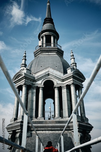 Vertical low angle shot of a building with a steeple in Roubaix, France photo