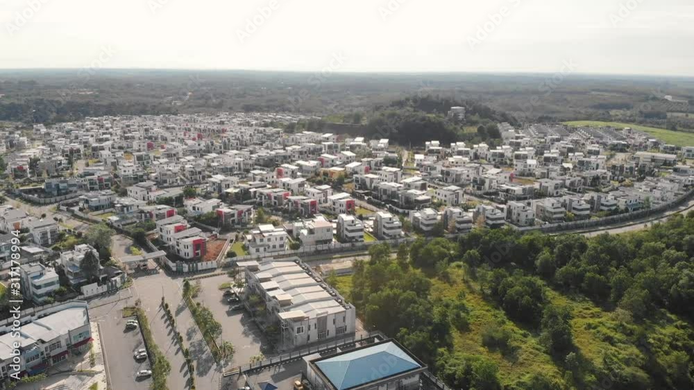 Drone view of modern integrated residential area with green agriculture as buffer zone. Pan to right Drone view of modern integrated residential area with green agriculture as buffer zone. Pan to right