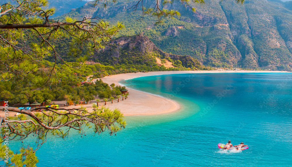Girls in bikini lying on air bed - Oludeniz Beach And Blue Lagoon, Oludeniz beach is best beaches in Turkey - Fethiye, Turkey