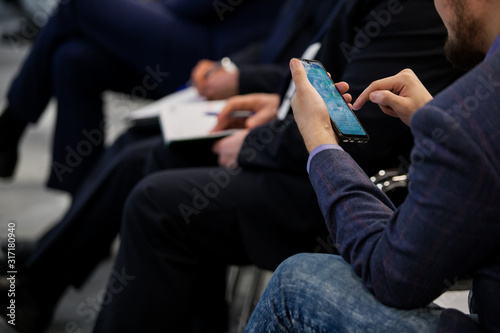 seminar, people type on the phone