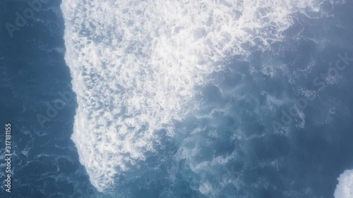 Overhead aerial camera captures the calm waves of the blue ocean (Ariya's Beach, Oregon, USA) photo