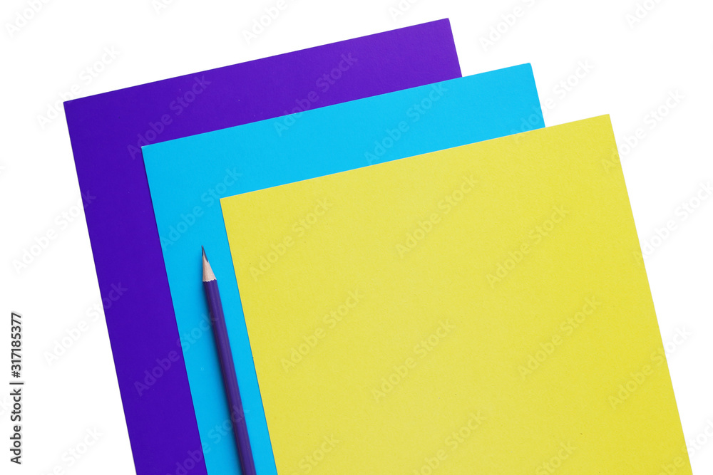 blue, cyan and yellow sheets of paper and pencil, copy space blue, cyan and yellow sheets of paper and pencil, copy space