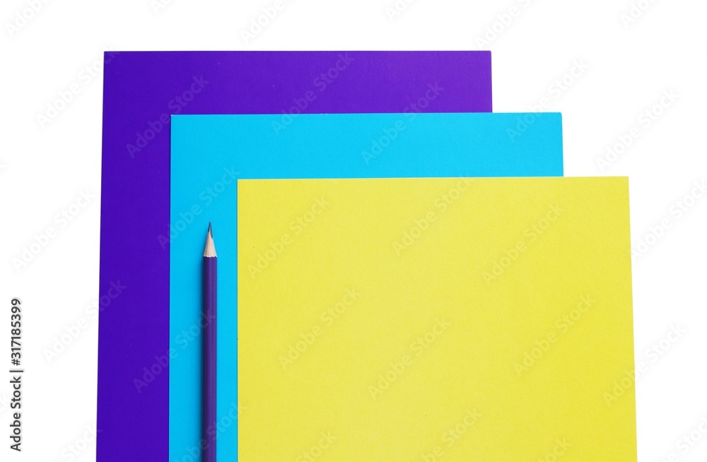 blue, cyan and yellow sheets of paper and pencil, copy space blue, cyan and yellow sheets of paper and pencil, copy space