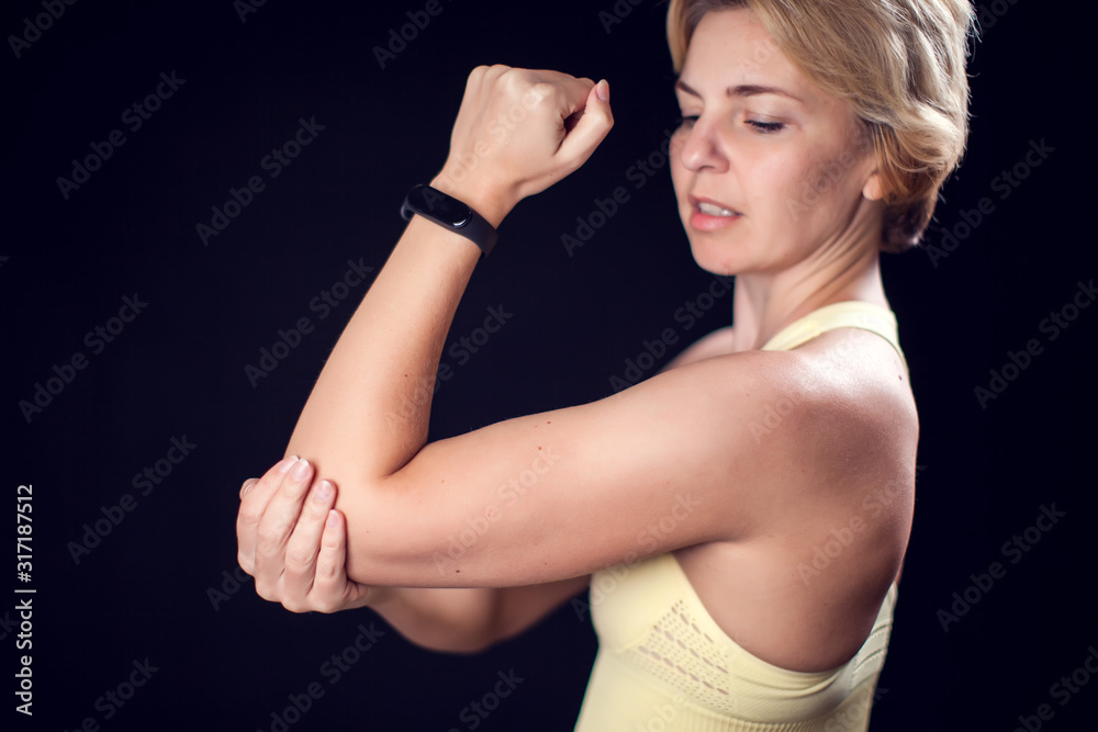 Woman feeling strong elbow pain. Fitness and healthcare concept Woman feeling strong elbow pain. Fitness and healthcare concept