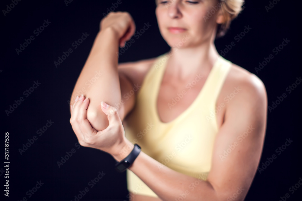 Woman feeling strong elbow pain. Fitness and healthcare concept Woman feeling strong elbow pain. Fitness and healthcare concept