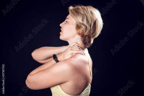 Woman feeling strong neck pain. Fitness and healthcare concept