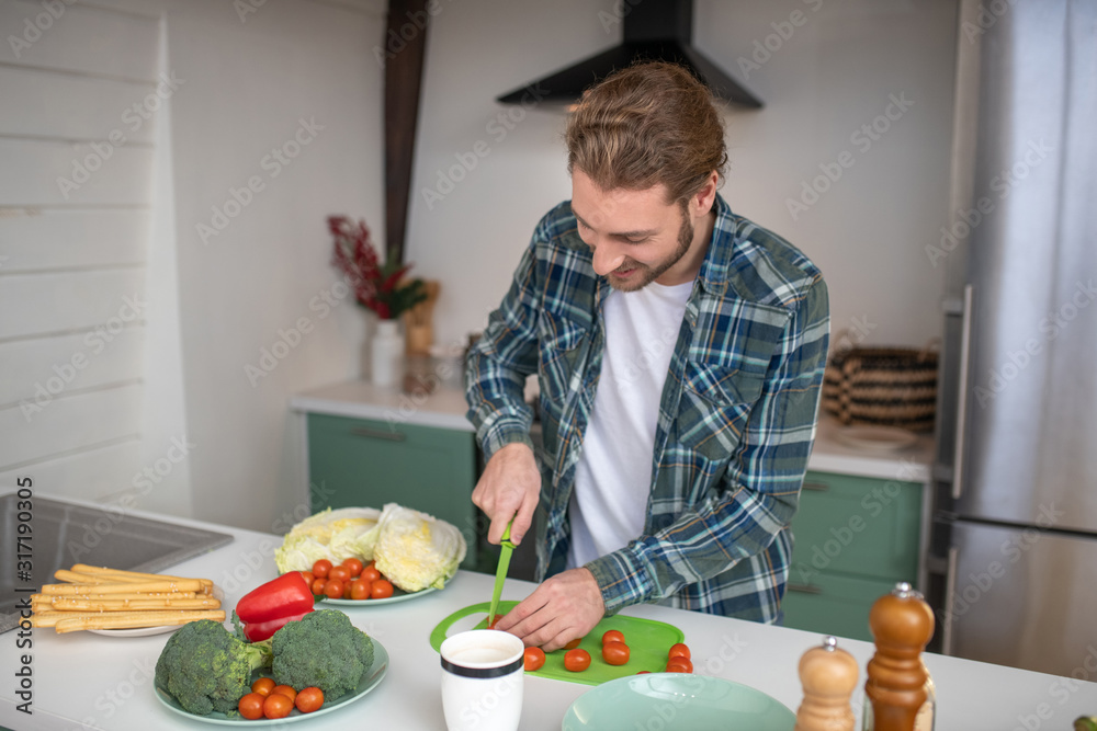 Man cutting vegetables for making a salad Man cutting vegetables for making a salad