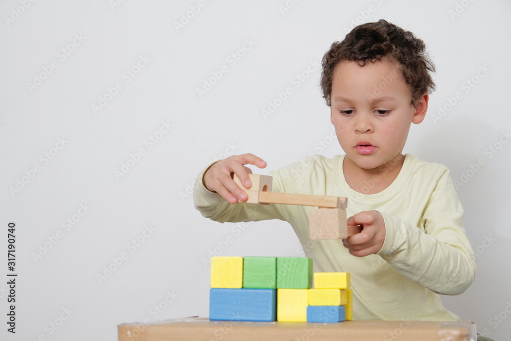 boy with toy building blocks testing his creativity by building towers learning and been educated at school boy with toy building blocks testing his creativity by building towers learning and been educated at school