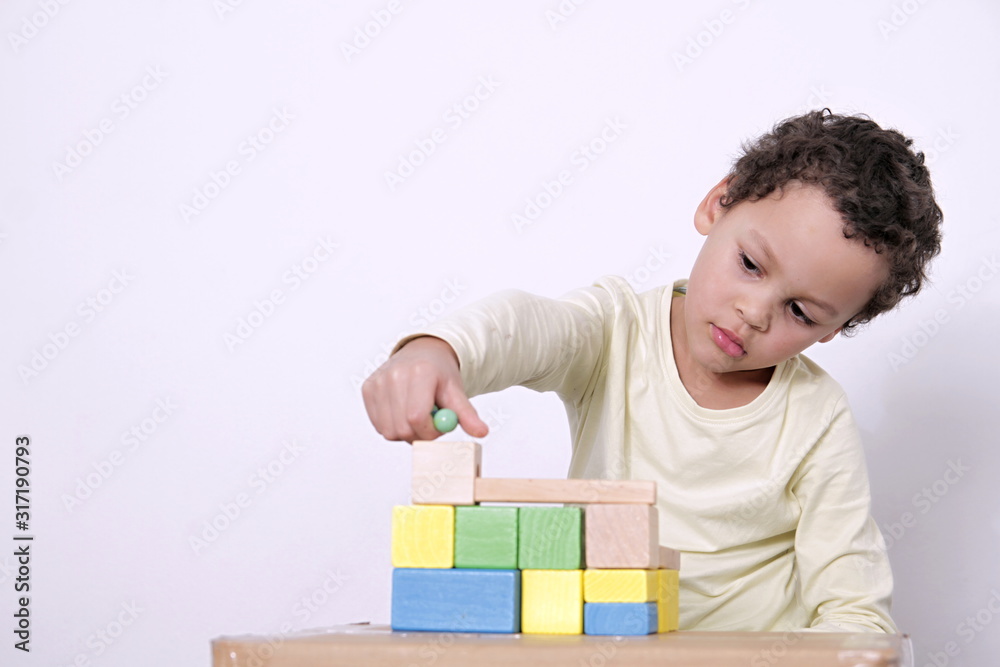 boy with toy building blocks testing his creativity by building towers learning and been educated at school boy with toy building blocks testing his creativity by building towers learning and been educated at school