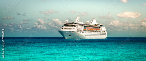 Cruise ship sailing on the Caribbean Sea. Side view of the vessel. Wide image. photo