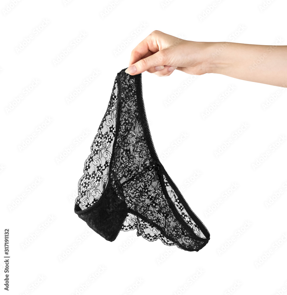 Hand holding black lace panties. Close up. Isolated on a white background  Stock Photo