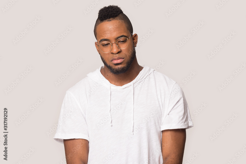 Upset black man look down thinking feeling sad Upset black man look down thinking feeling sad