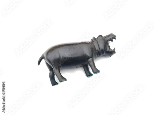 a plastic hippopotamus toy isolated on white background © rajiv