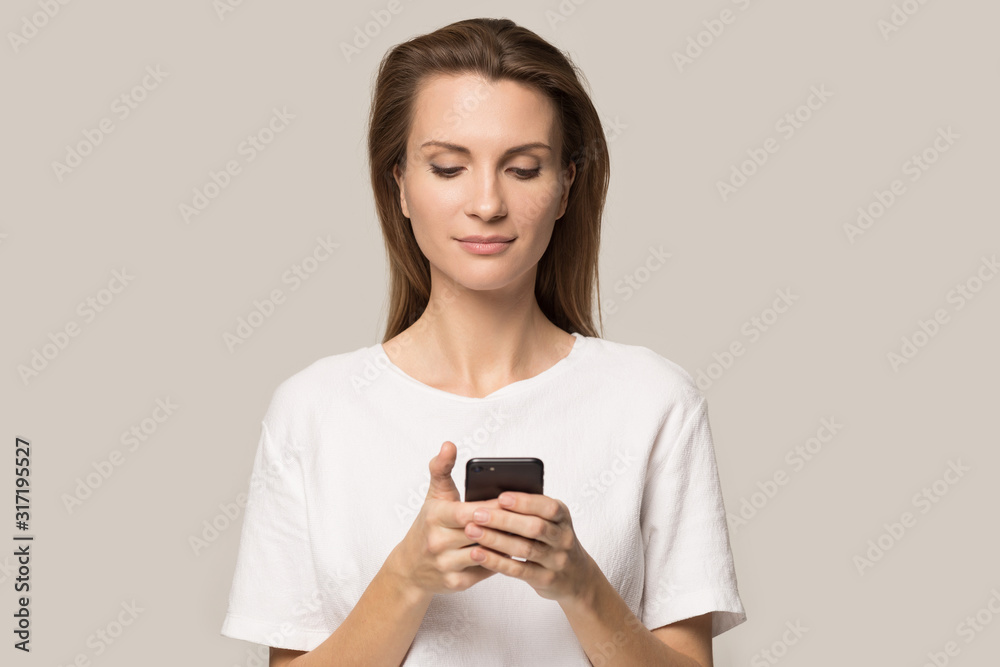 Young woman using cellphone messaging or browsing internet Young woman using cellphone messaging or browsing internet
