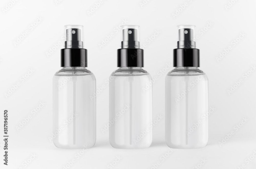 Three spray bottles for cosmetics product with transparent liquid on white background, mock up for branding, advertising, design. Three spray bottles for cosmetics product with transparent liquid on white background, mock up for branding, advertising, design.