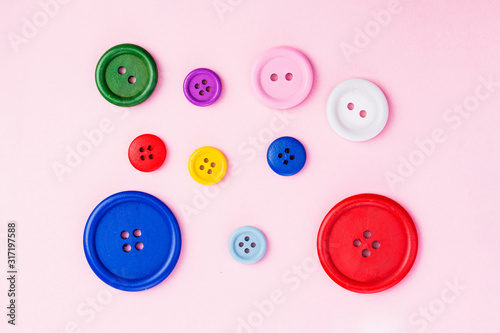 Pastel plastic buttons on pink