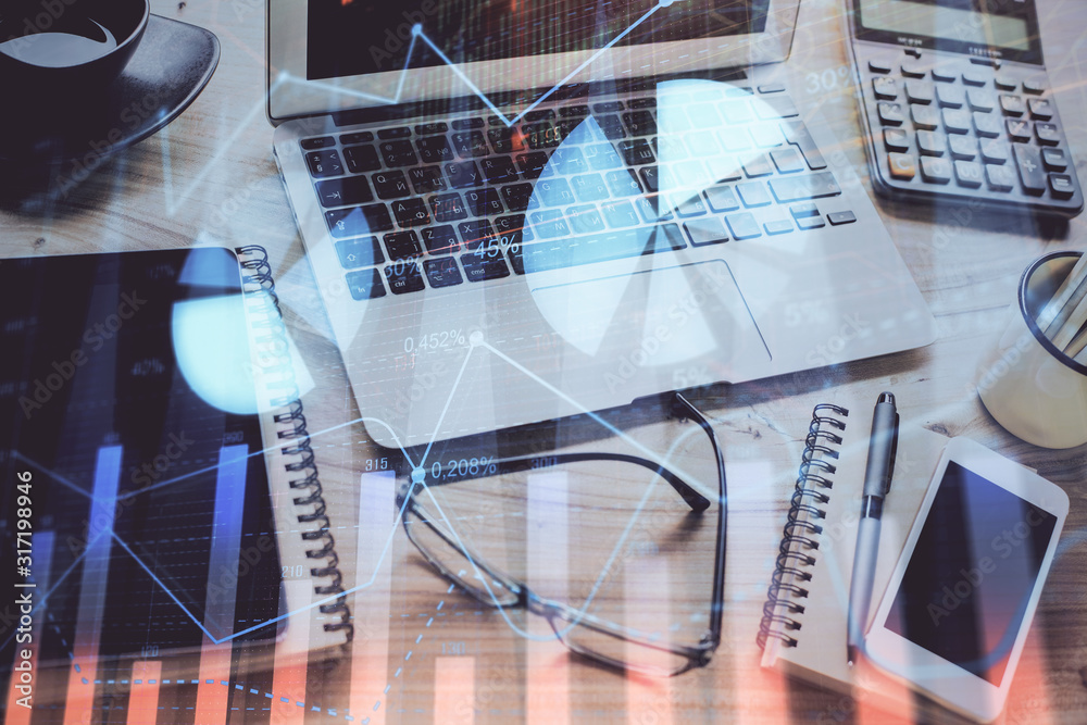 Stock market chart hologram drawn on personal computer background. Double exposure. Concept of investment. Stock market chart hologram drawn on personal computer background. Double exposure. Concept of investment.
