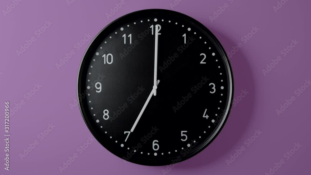 Black Clock Face in Time lapse all day on Magenta Purple wall Black Clock Face in Time lapse all day on Magenta Purple wall