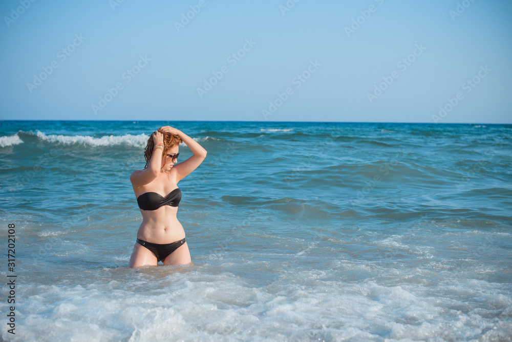 Plus size nice young woman with full hips and pretty figure in fashionable swimsuit rest at sea, vacation and trip concept Plus size nice young woman with full hips and pretty figure in fashionable swimsuit rest at sea, vacation and trip concept