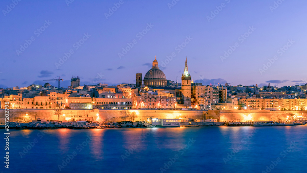 Panorama of Valletta at night, seafront skyline of the capital city of Malta from Sliema shoreline