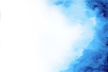 Abstract blue watercolor paint on white paper background