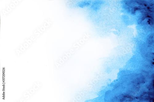 Abstract blue watercolor paint on white paper background © zomjeed