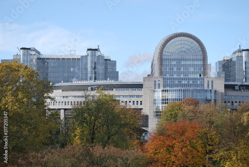 This photo shows beautiful autumn trees and the building of the European Parliament