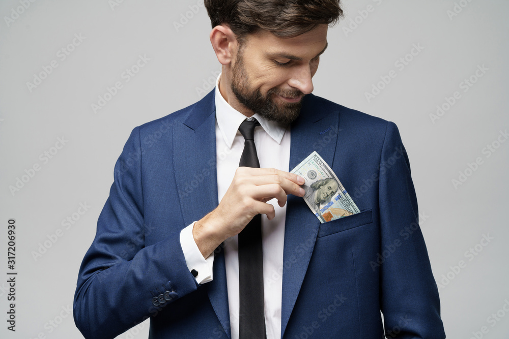 young handsome businessman holding US dollar bill young handsome businessman holding US dollar bill
