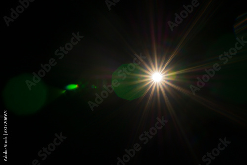 Abstract of sun lighting for background. Digital lens flare on black background. Easy to add overlay or screen filter for photos design. Sun, star, space, glow effect. 