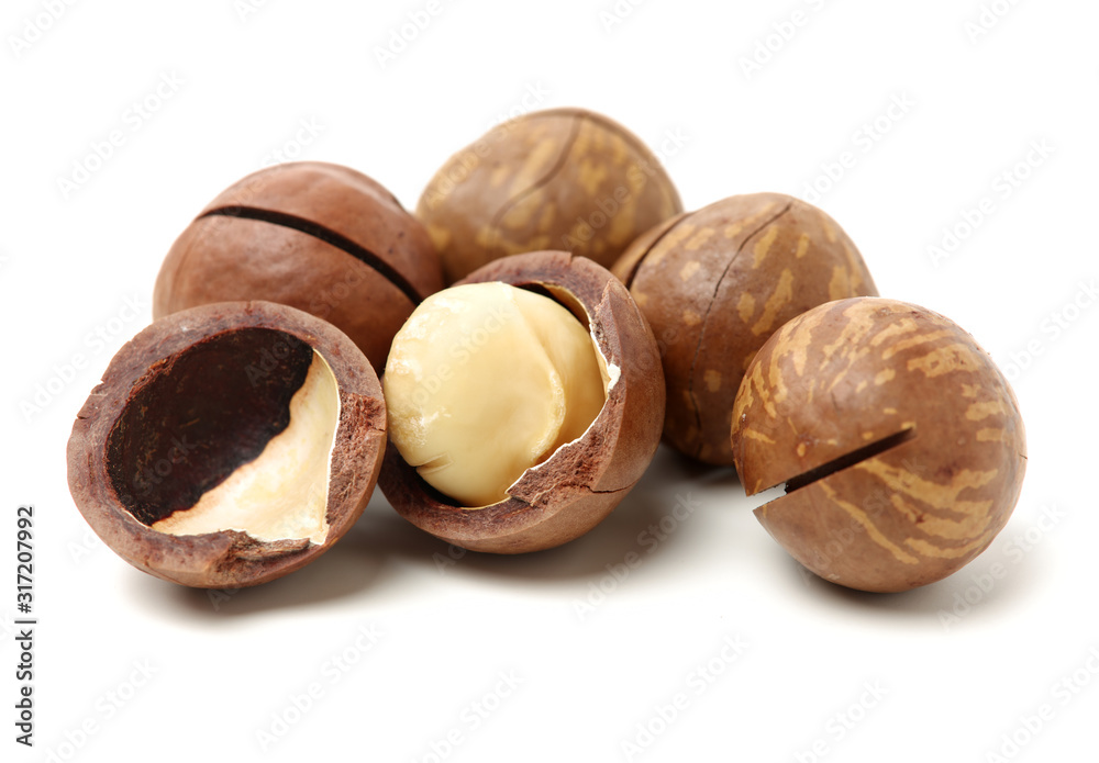 Shelled and unshelled macadamia nuts on white background Shelled and unshelled macadamia nuts on white background
