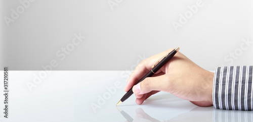 Pen in hand on a white background