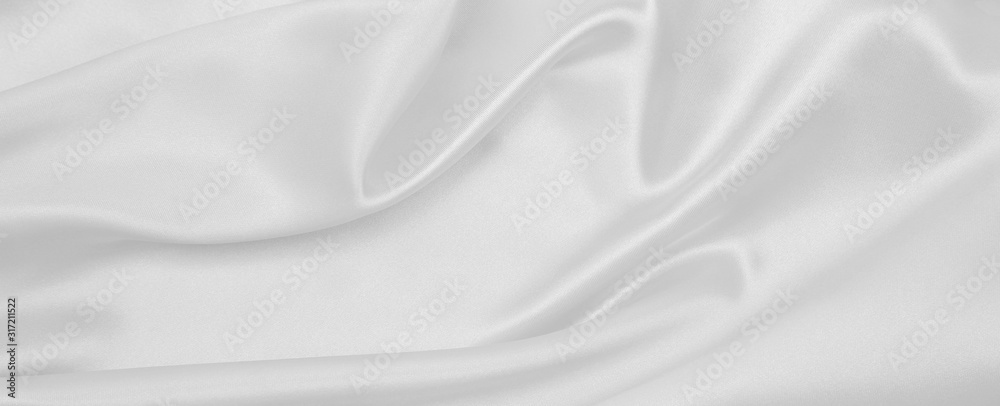 Smooth elegant white silk or satin luxury cloth texture as wedding background. Luxurious background design