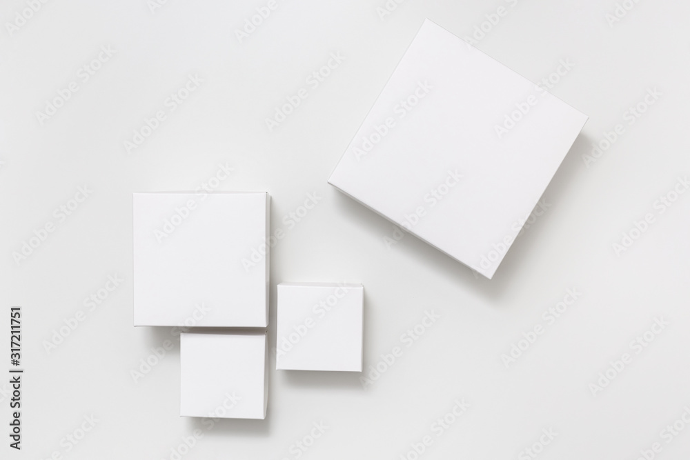 Mock up of four different size white boxes on the white background Mock up of four different size white boxes on the white background