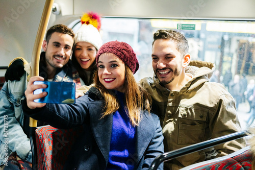 Photography A group of friends take a selfie on an urban bus