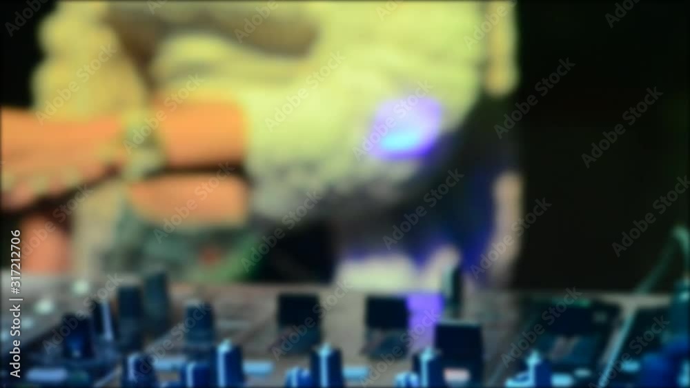 Blur Close-Up of Dj Mixer Controller Desk in Night Club Disco Party. DJ Hands touching Buttons and Sliders Playing Electronic Music Blur Close-Up of Dj Mixer Controller Desk in Night Club Disco Party. DJ Hands touching Buttons and Sliders Playing Electronic Music