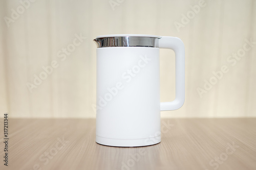 White kettle, modernist, on a wooden table