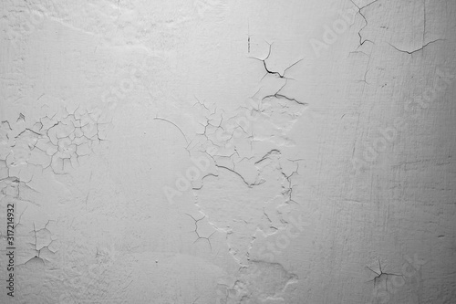 Fotografie Closeup of paint cracks on a white wall, old wall.