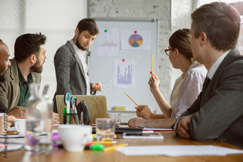 Brainmapping. Group of young business professionals having a meeting. Diverse group of coworkers discuss new decisions, plans, results, strategy. Creativity, workplace, business, finance, teamwork. photo