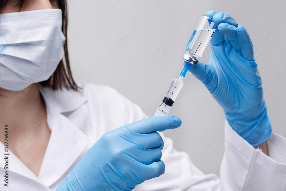 Medical injection,diseases,health care,science,diabetes.Doctor or nurse in hospital holding a syringe with liquid vaccines preparing to do an injection.Medical equipment. People in white uniform,robe. Medical injection,diseases,health care,science,diabetes.Doctor or nurse in hospital holding a syringe with liquid vaccines preparing to do an injection.Medical equipment. People in white uniform,robe.