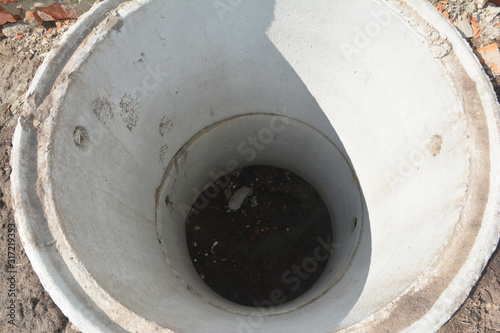 Installing concrete septic tank. Sewer tank hole installation outdoors top view