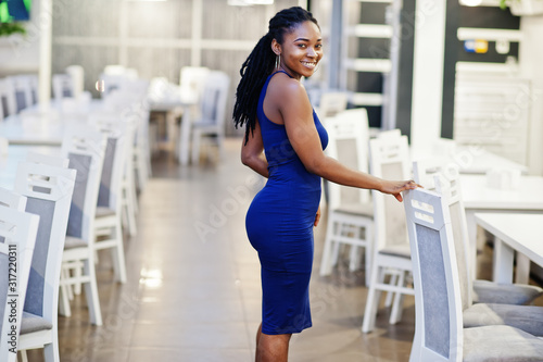 Charming african american woman posing at restaurant.