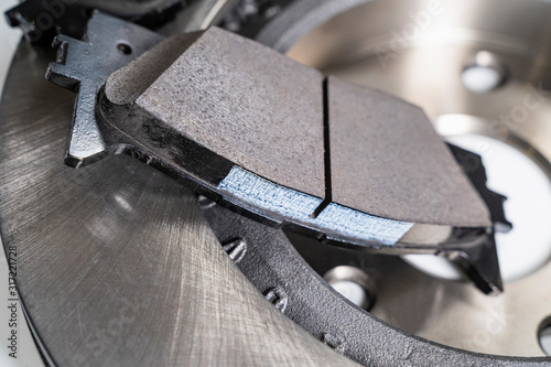 brake pads and auto parts on a white table photo