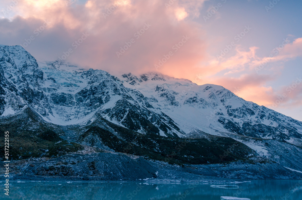 Mountain landscape with snow covered mountain range at sunset