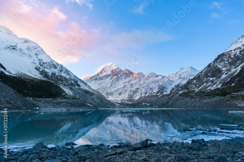 Winter mountain landscape with glacier lake at sunset