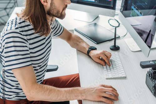 cropped view of art editor using computer keyboard