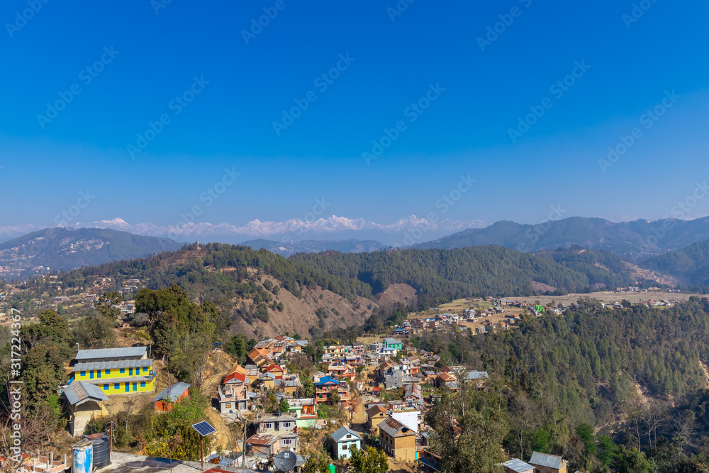 Nepali village in the hills. Great Himalaya Range in the backdrop