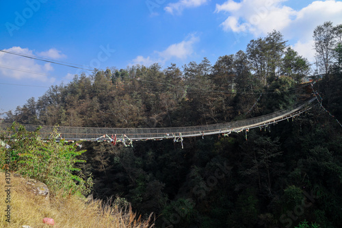 A suspension bridge in the hills over the river