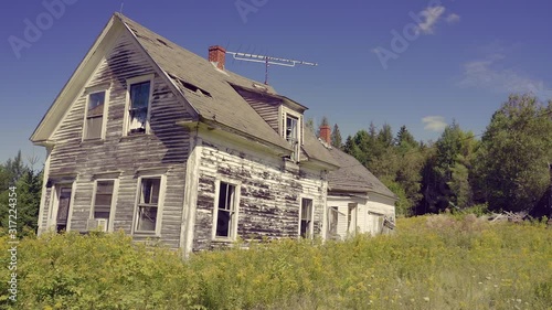 Aerial: Abandoned house on a meadow. Haynesville, Maine, USA photo