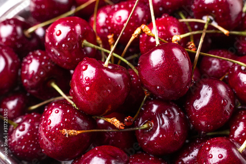 Close up of fresh cherry berries. Drops of water on the surface of berries. Selective focus. Macro background