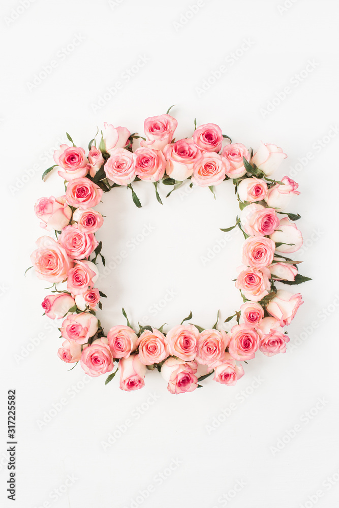 Flat lay square frame border with blank copy space mockup made of pink rose flower buds on white background. Top view floral concept.